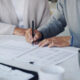 Estate Planning Documents - Cropped shot of a senior couple meeting with a consultant to discuss paperwork at home