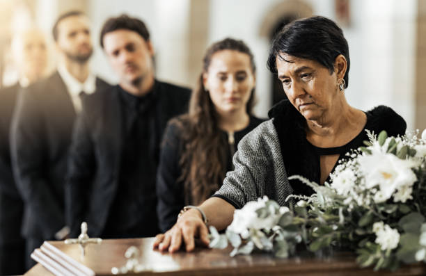 Intestate Succession Law - Funeral, death and coffin in church or Christian family gathering together for support. Religion, sad people and mourning loss or religious catholic men and women grief in church service over casket